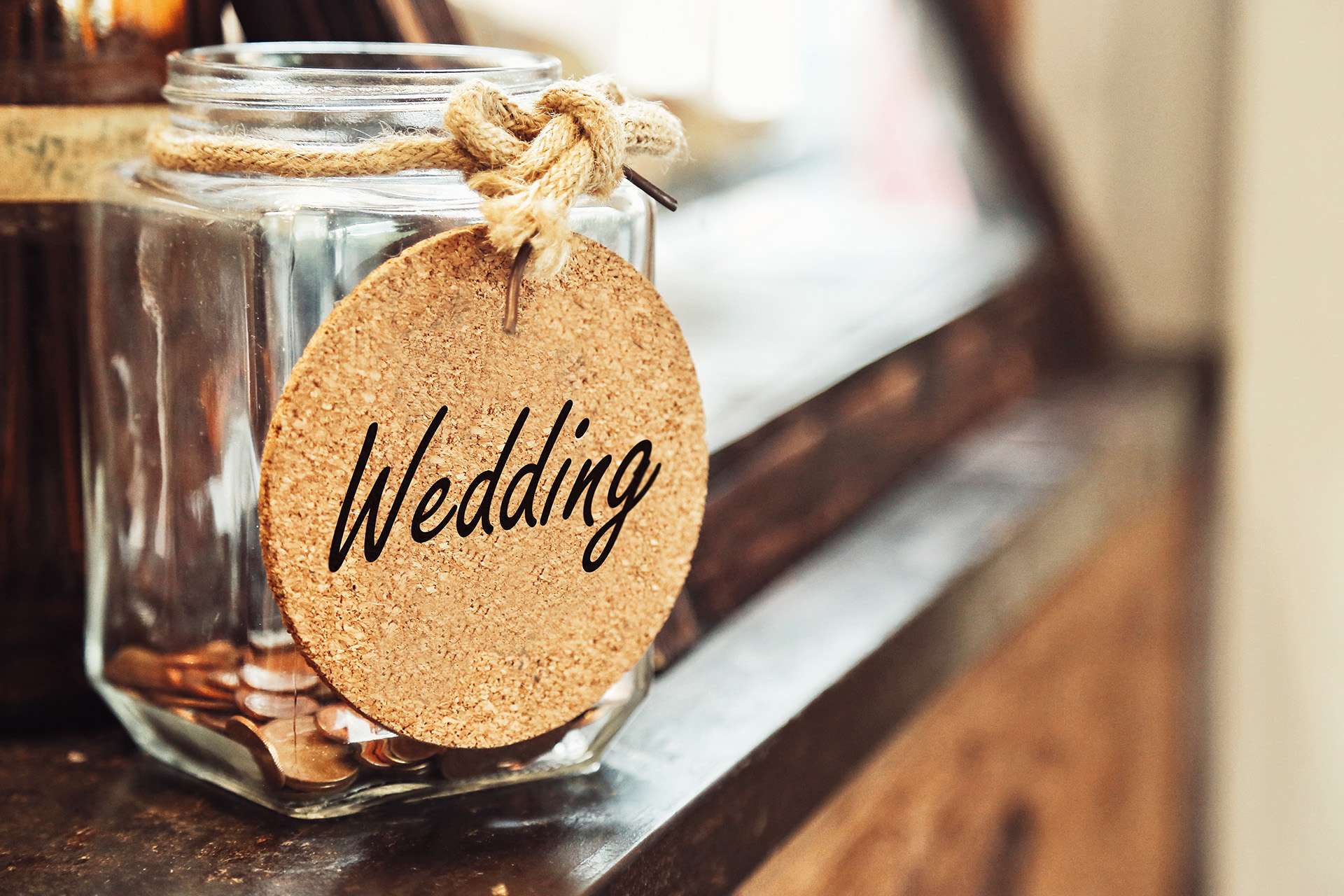 Image of a wedding savings jar filled with coins